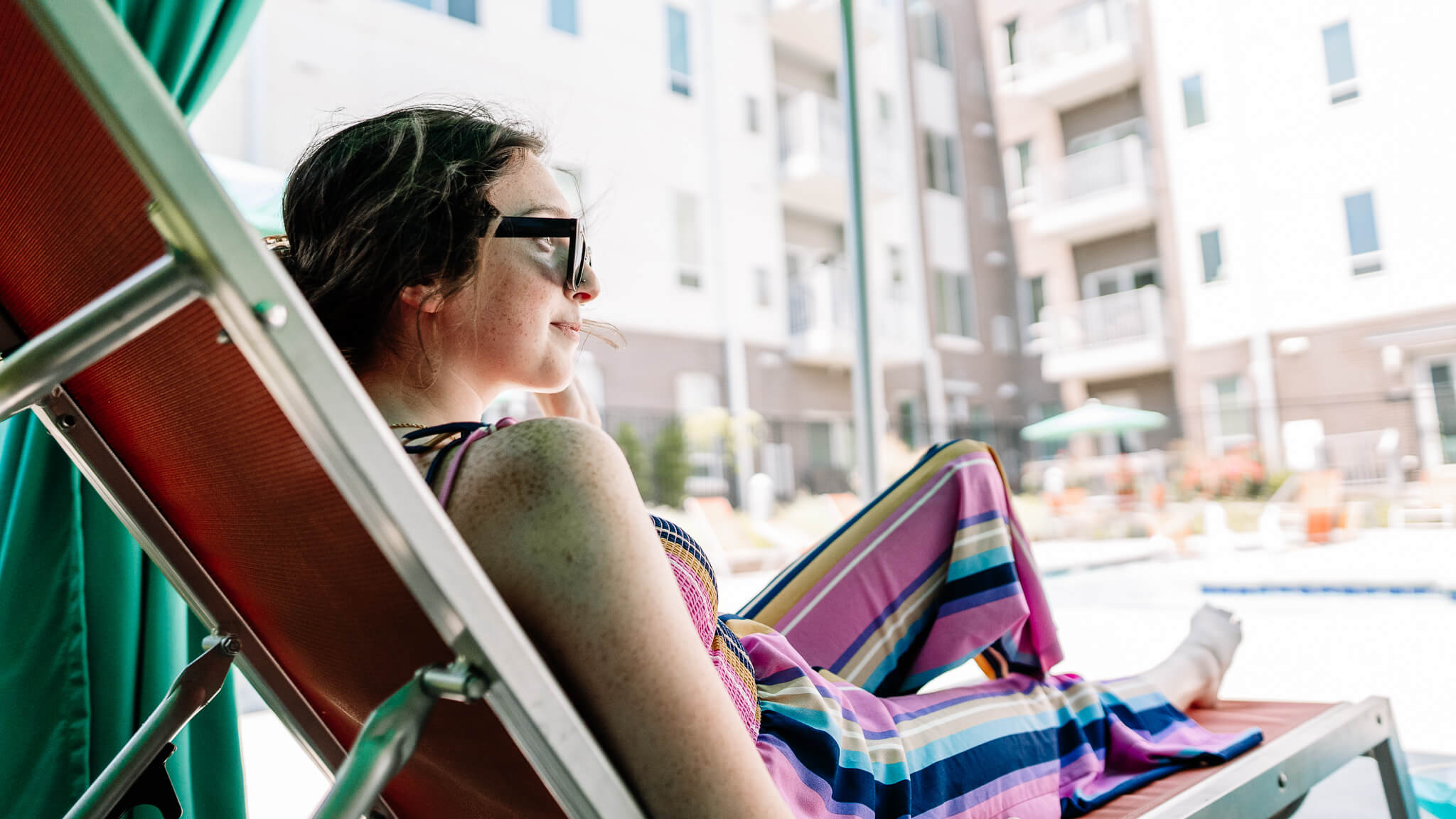 resident sitting poolside at the Corvina